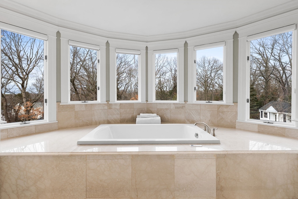 6 Jonas Stone Circle Lexington, MA 02420 - Photo 26 of 42 a living room with a large window couches and a flat screen tv