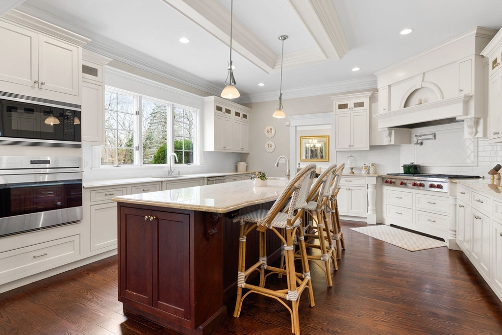 6 Jonas Stone Circle Lexington, MA 02420 - Photo 8 of 42 a kitchen with stainless steel appliances granite countertop a kitchen island hardwood floor sink stove dining table and chairs
