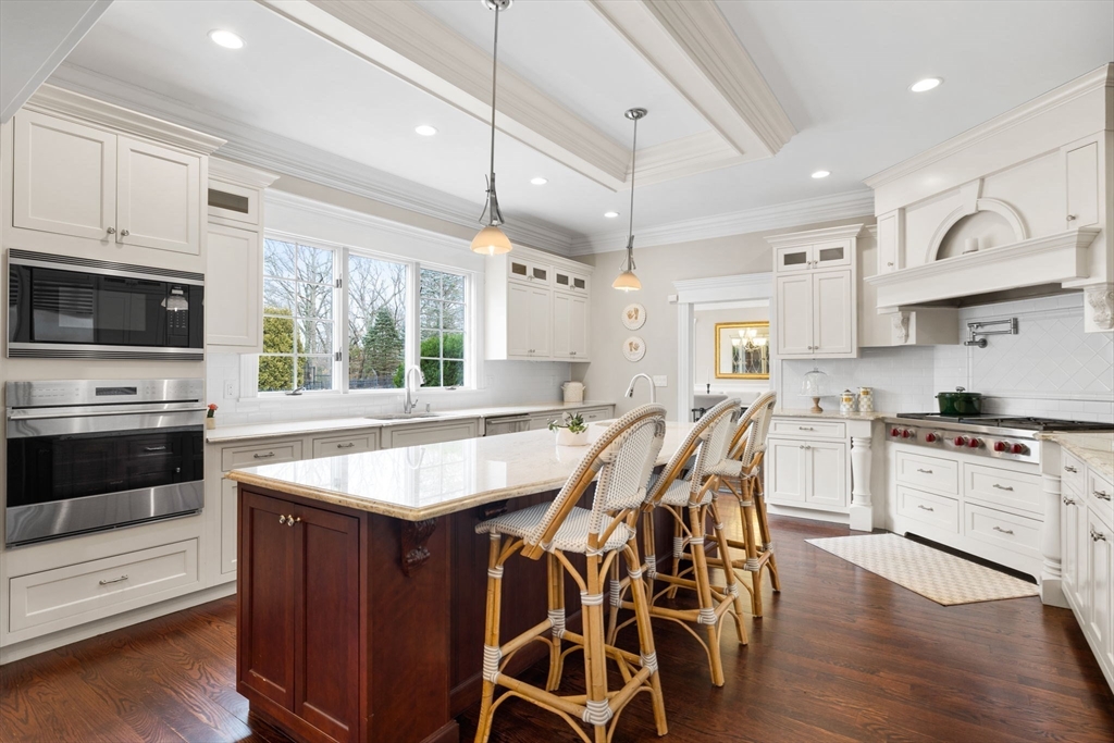 6 Jonas Stone Circle Lexington, MA 02420 - Photo 10 of 42 a kitchen with stainless steel appliances granite countertop a stove a sink dishwasher a microwave oven with white cabinets and wooden floor