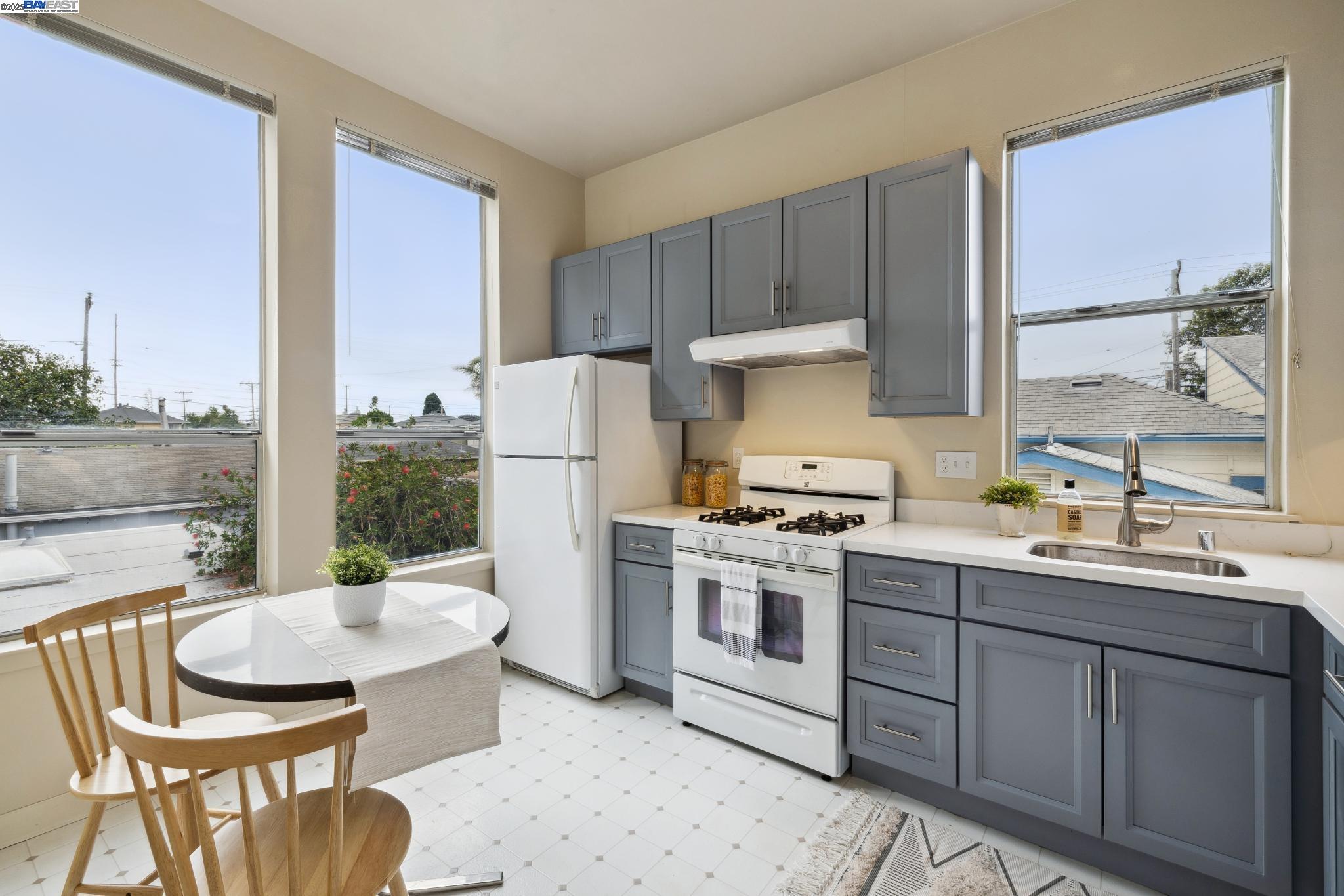 1820 3rd Street Alameda, CA 94501 - Photo 13 of 60 a kitchen with a stove a sink and a refrigerator