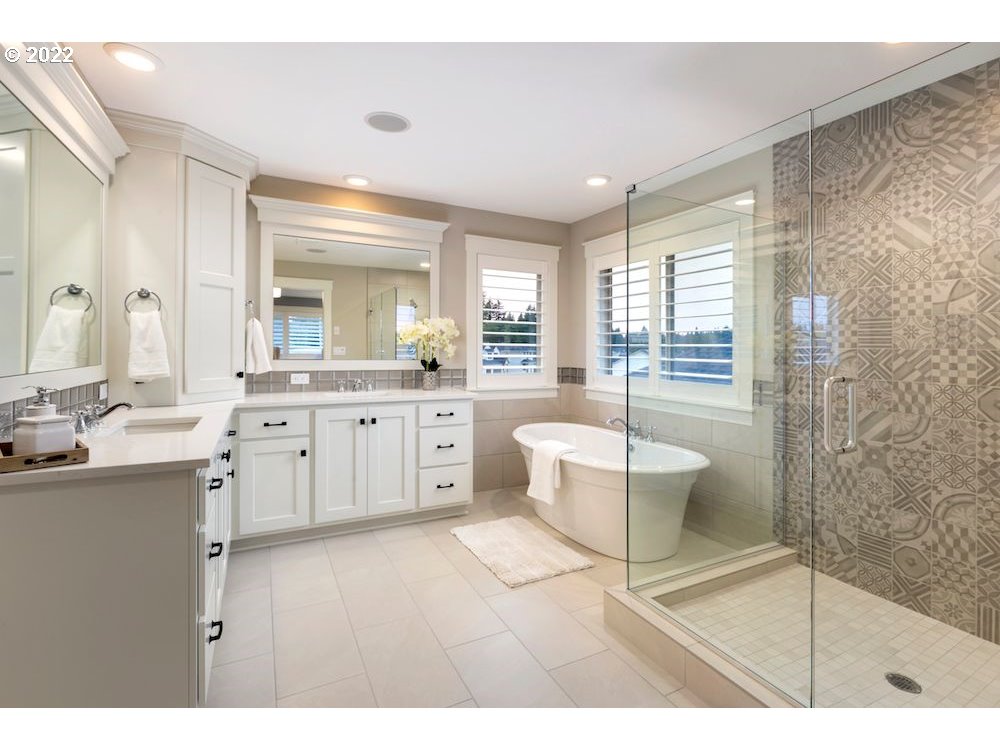1291 South 44th Avenue Ridgefield, WA 98642 - Photo 3 of 10 a spacious bathroom with a granite countertop sink a toilet a mirror and shower