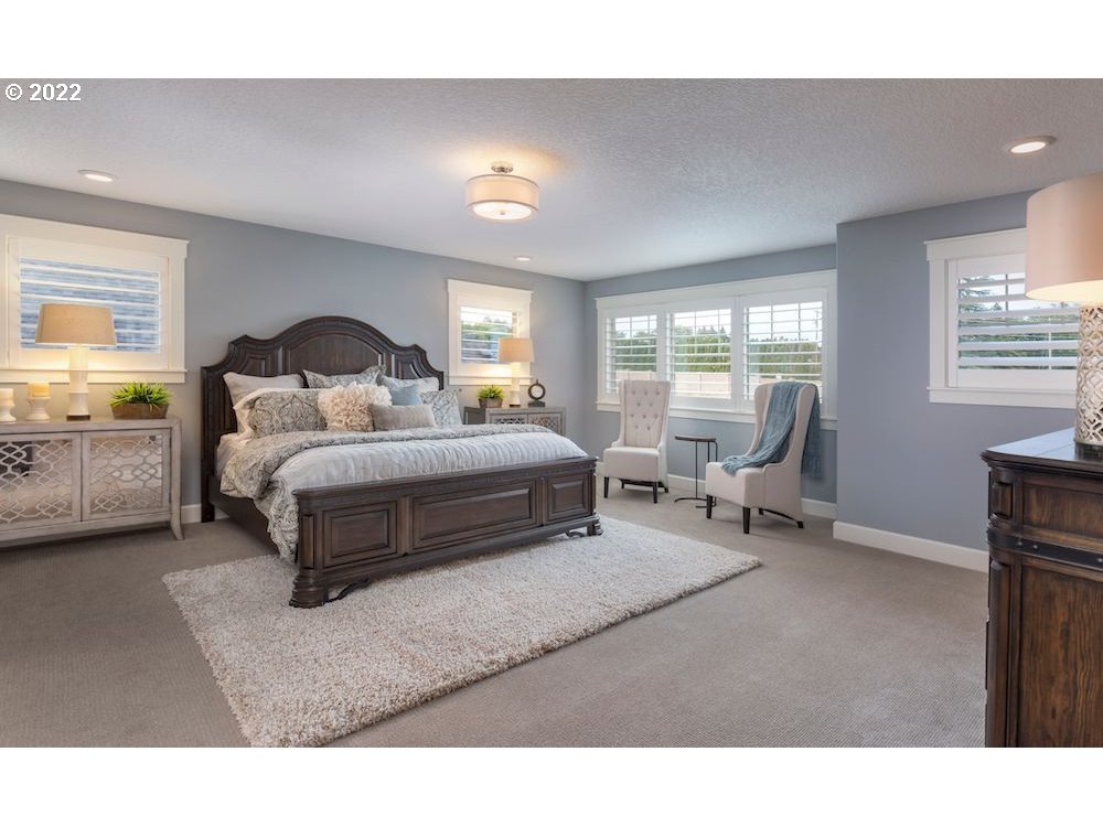 1291 South 44th Avenue Ridgefield, WA 98642 - Photo 9 of 10 a bedroom with a bed a lamp and a large window