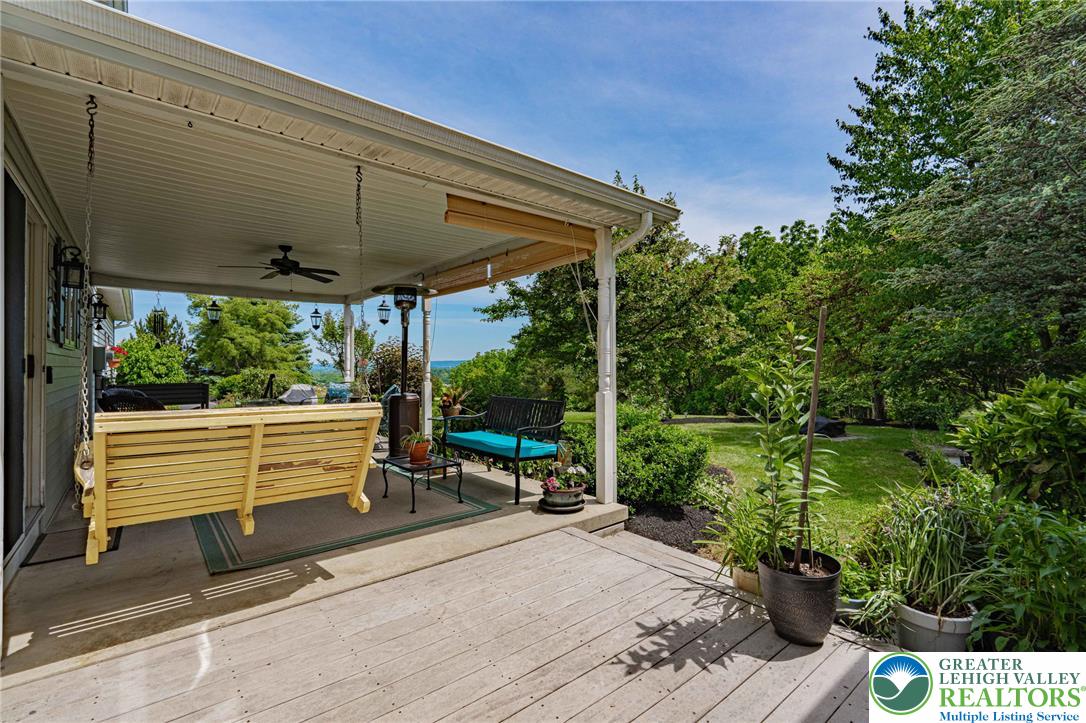 4542 Springfield Drive Coplay, PA 18037 - Photo 64 of 89 An inviting covered patio offers a tranquil retreat with sweeping views of the surrounding natural beauty.