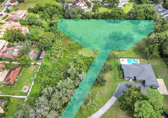 an aerial view of green landscape with trees houses and mountain view