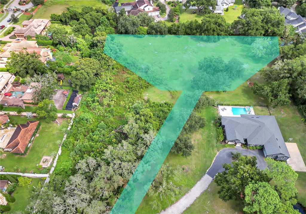 an aerial view of green landscape with trees houses and mountain view