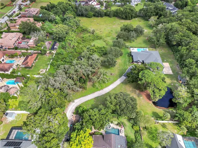 an aerial view of residential house with outdoor space and swimming pool