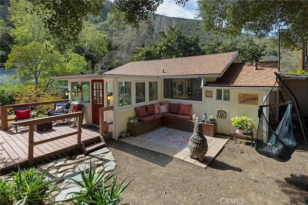 a view of a patio with a table chairs and a yard