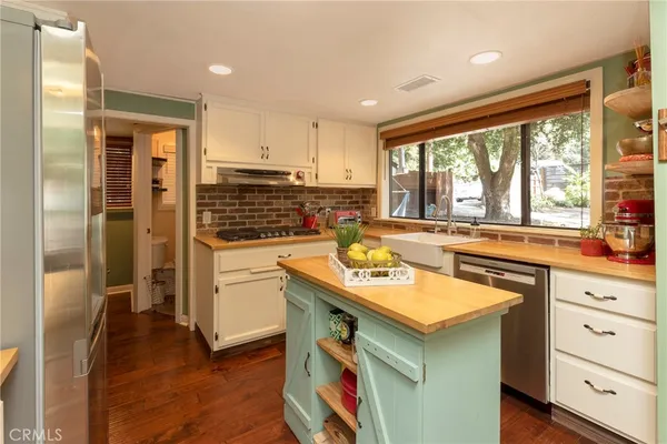 a kitchen with a sink stove and refrigerator