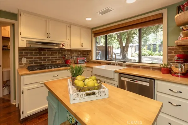 a kitchen with a stove a sink and a refrigerator