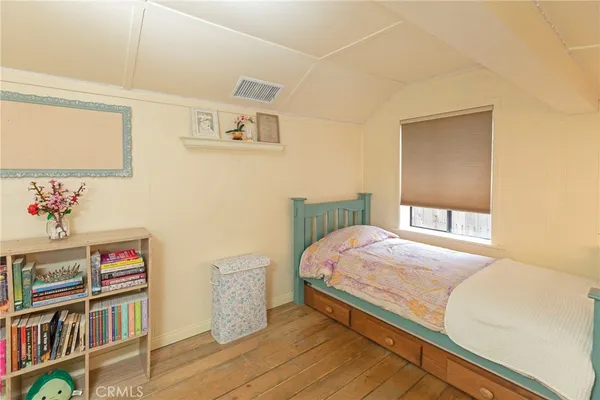 a bedroom with a bed and a book shelf