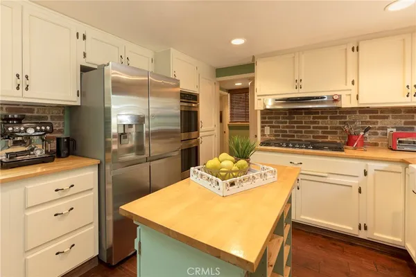 a kitchen with a refrigerator and cabinets