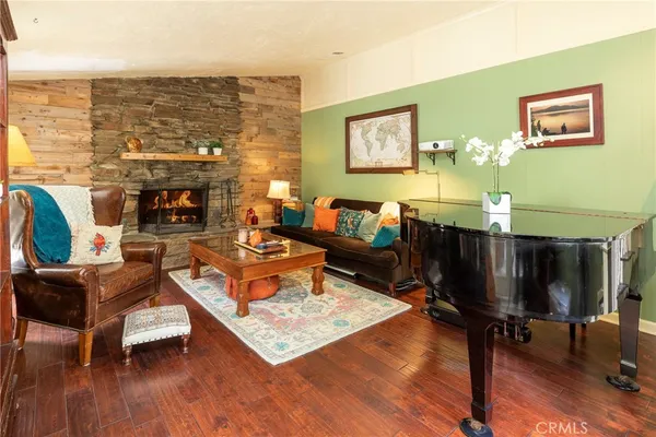a living room with fireplace furniture and a floor to ceiling window