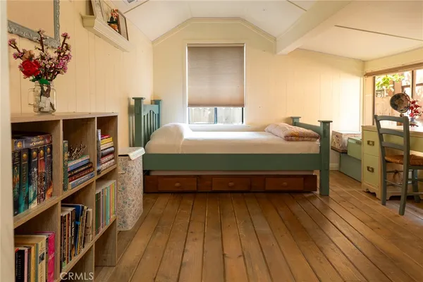 a bedroom with a bed furniture and a chandelier