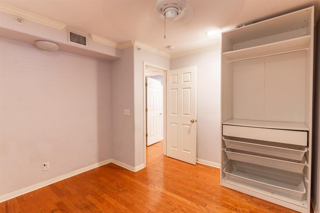 3009 Speedway, Unit 2 Austin, TX 78705 - Photo 9 of 10 Hardwood floors and bright lighting enhance this versatile secondary bedroom, featuring convenient closet organization.
