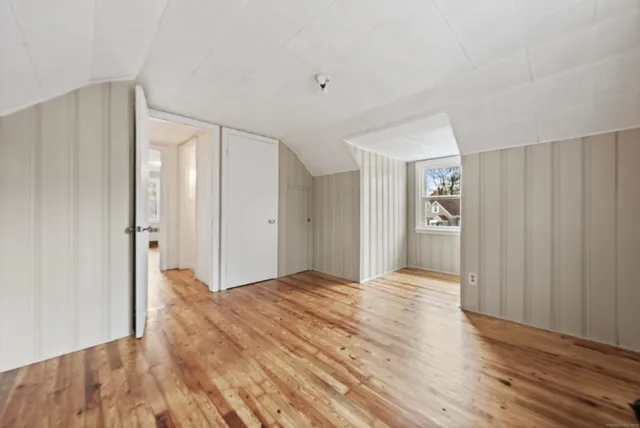 a view of empty room with wooden floor
