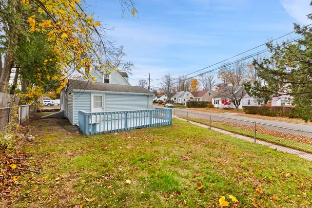 a view of a house with pool and sitting area