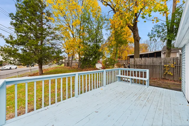 a balcony with wooden floor and trees