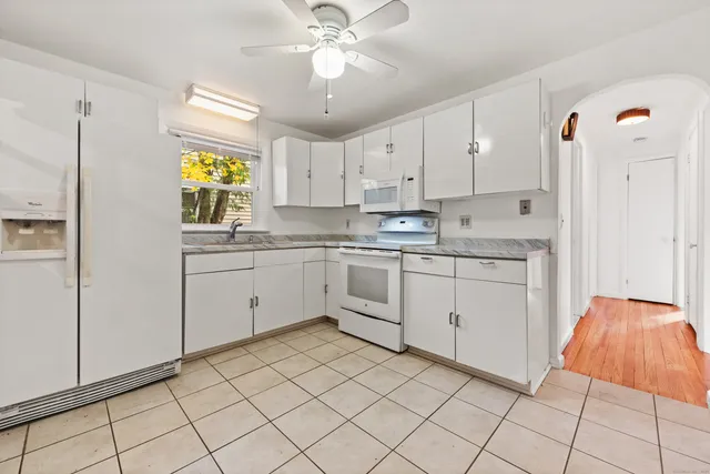 a kitchen with a sink cabinets and window