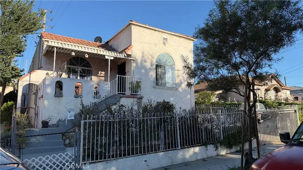 a view of a house with a small yard and furniture