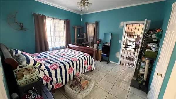 a bed sitting in a bedroom next to a window
