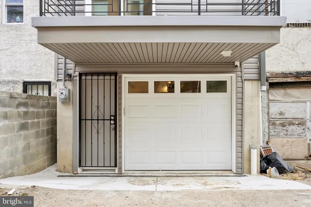 a kitchen with stainless steel appliances a refrigerator a stove a sink dishwasher a dining table and chairs with wooden floor