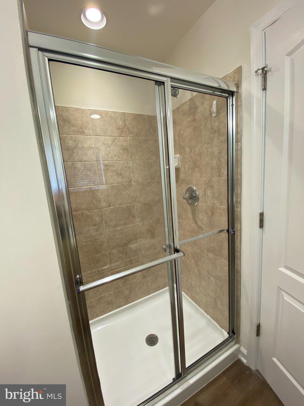 128 Tuxford Road Falling Waters, WV 25419 - Photo 18 of 27 Sleek modern shower with elegant tiles.