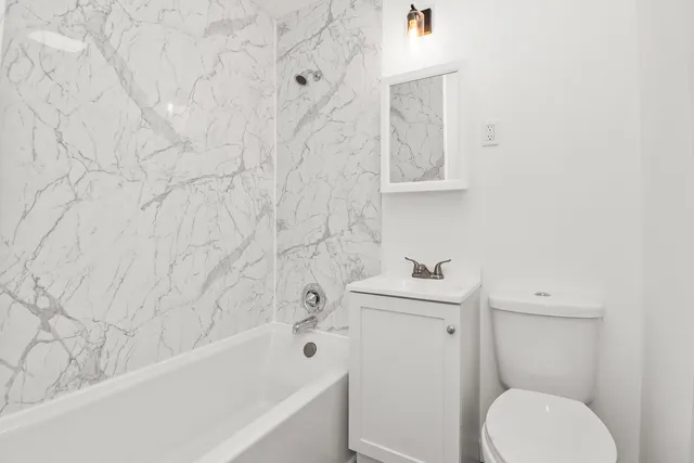 a bathroom with a sink toilet and bathtub