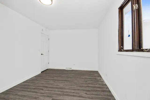 a view of a room with wooden floor