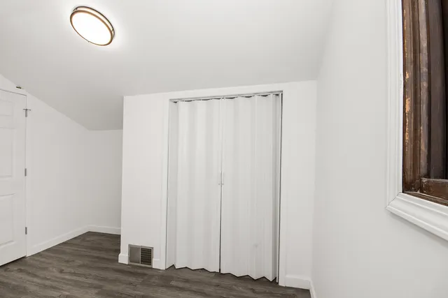 a view of a room with wooden floor