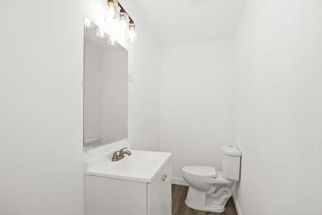 a bathroom with a sink a toilet and mirror