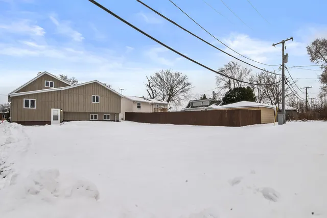 a view of a house with a snow in the yard