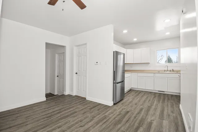 a kitchen with white cabinets and white appliances