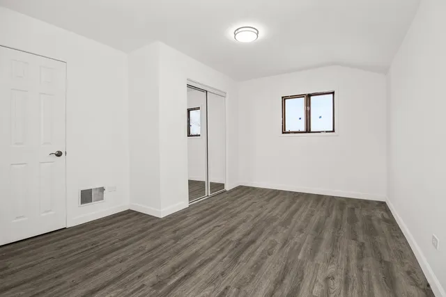 an empty room with wooden floor