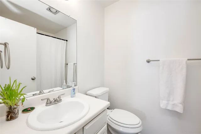 a bathroom with a sink a mirror and a toilet