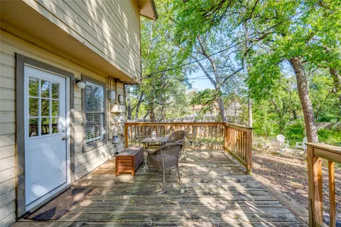 a balcony with chairs and a table