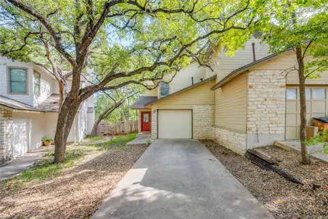 a view of a house with a yard and tree
