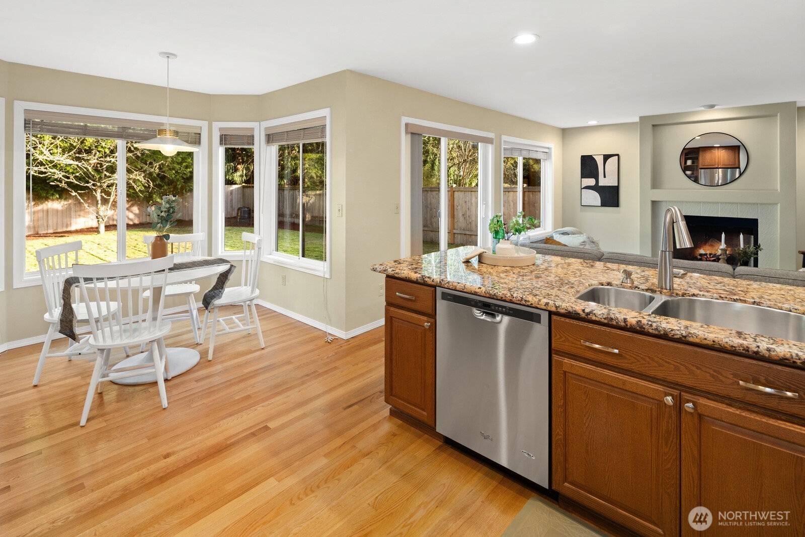 16708 5th Avenue Northeast Shoreline, WA 98155 - Photo 12 of 38 a open kitchen with granite countertop wooden floor a dining table and chairs