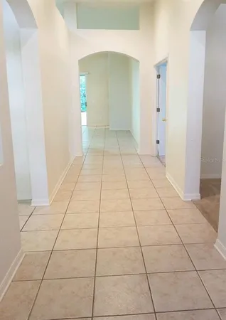a view of empty room with window and bathroom