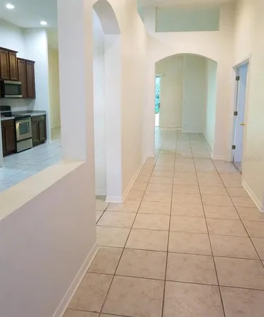 a view of a kitchen with an empty space and a window
