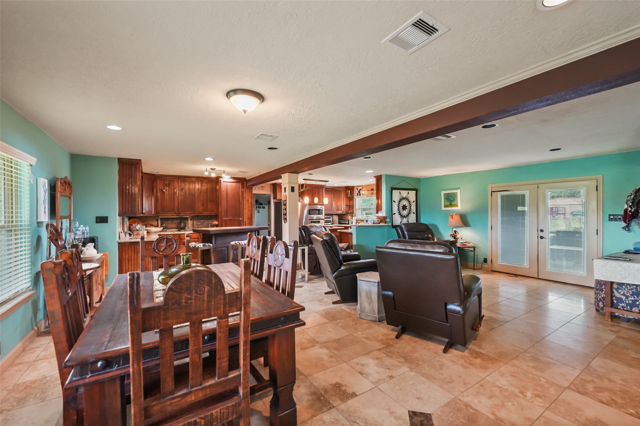 34366 Owens Road Hempstead, TX 77445 - Photo 7 of 46 Open-concept layout seamlessly connecting the dining area, kitchen, and living room, creating a spacious and functional setting for everyday living and entertaining.