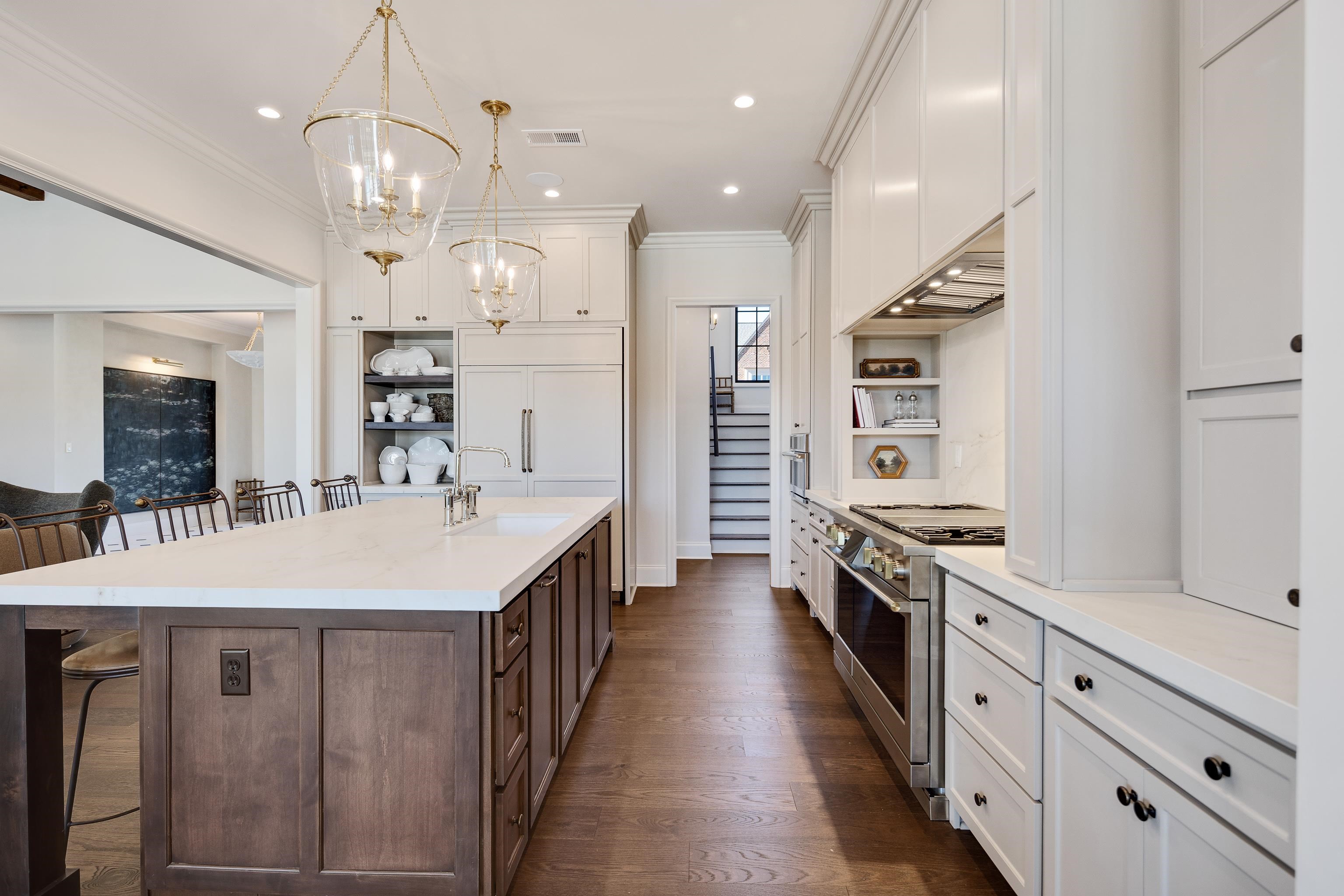 3280 Hidden Creek Loop West Collierville, TN 38017 - Photo 11 of 40 an open kitchen with wooden floor and stainless steel appliances