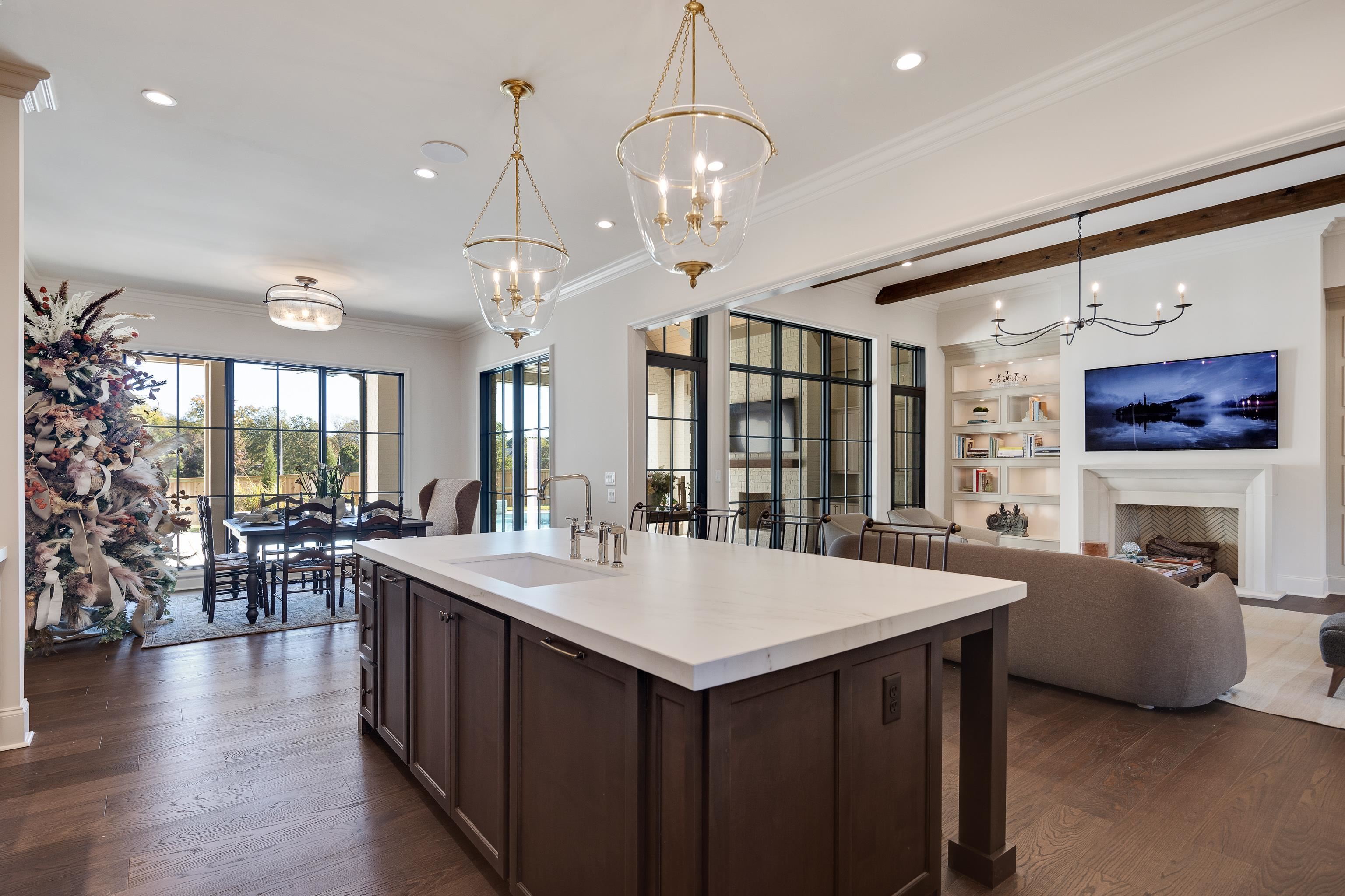 3280 Hidden Creek Loop West Collierville, TN 38017 - Photo 12 of 40 a large living room with stainless steel appliances granite countertop furniture a fireplace and a chandelier