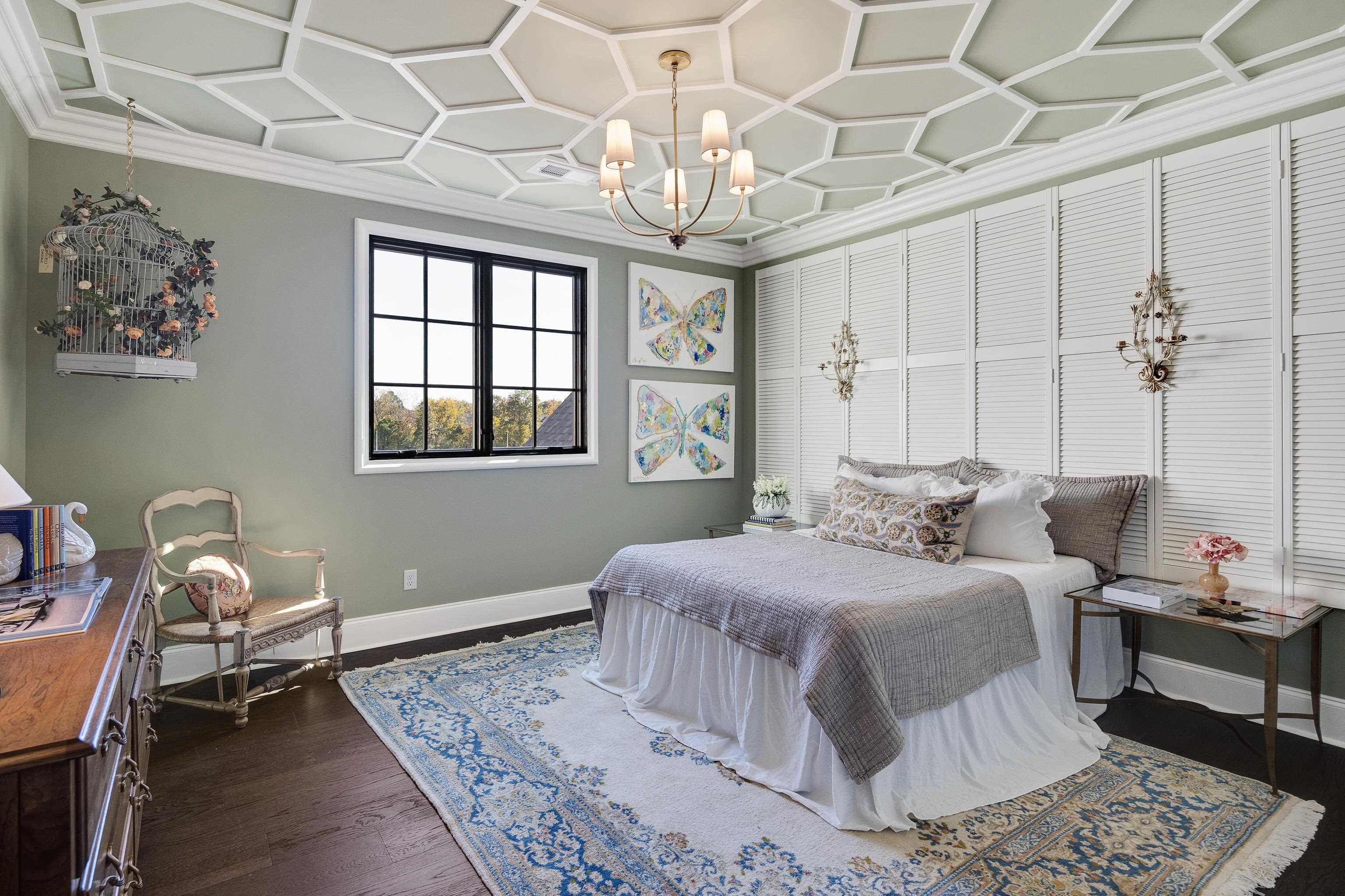 3280 Hidden Creek Loop West Collierville, TN 38017 - Photo 29 of 40 a bedroom with a bed and a chandelier