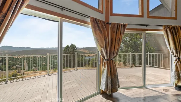 a view of a lush green outdoor space with a swimming pool