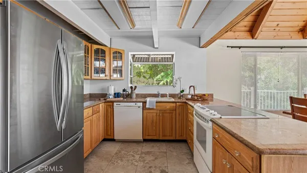 an aerial view of a houses with a yard and lake view
