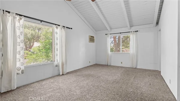 a kitchen with stainless steel appliances granite countertop a refrigerator a sink dishwasher a stove and white countertops with wooden floor