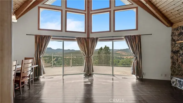 a view of a livingroom with wooden floor and stairs