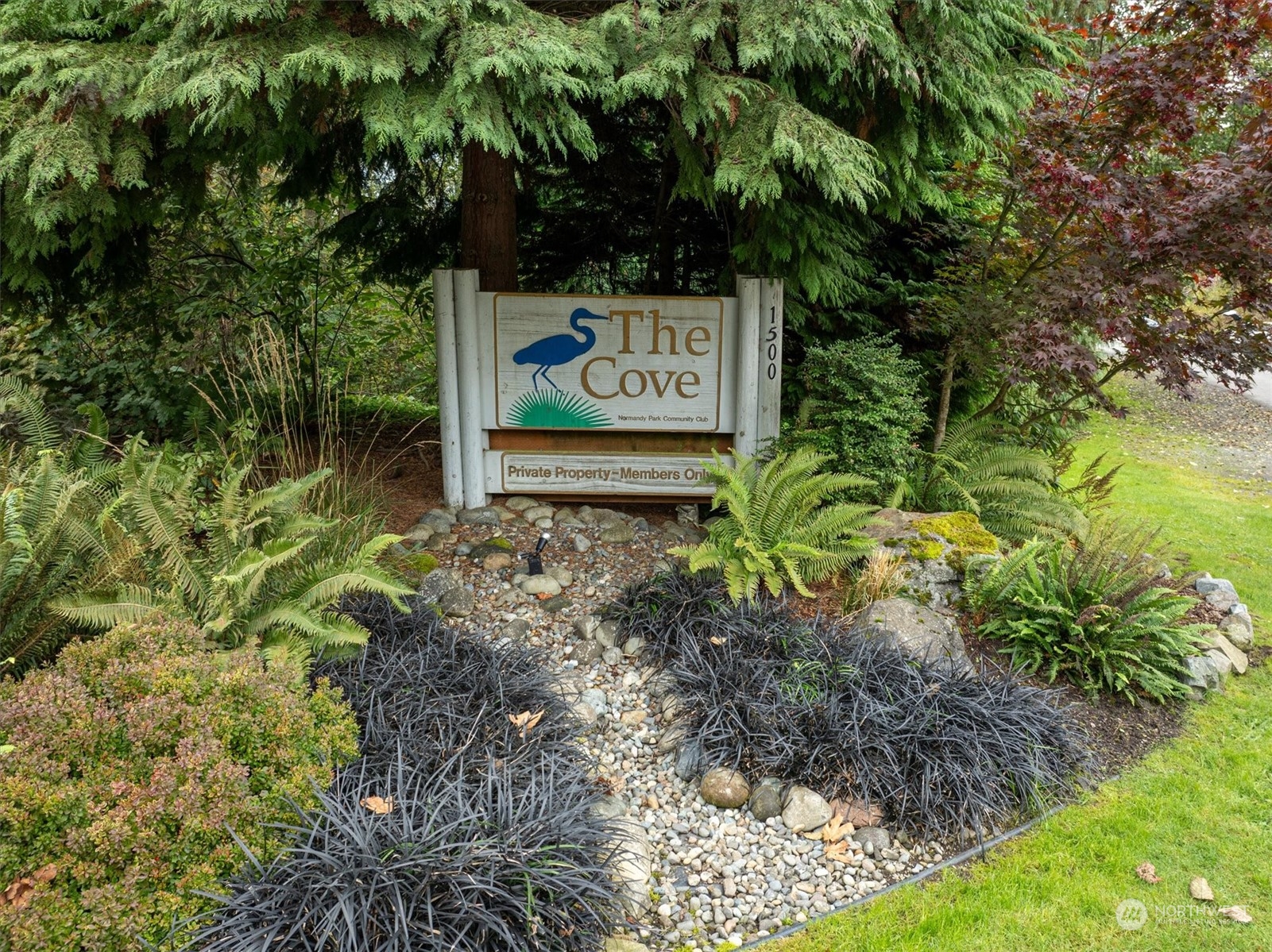 1360 Southwest 175th Street Normandy Park, WA 98166 - Photo 25 of 29 a sign that is sitting in the middle of a garden