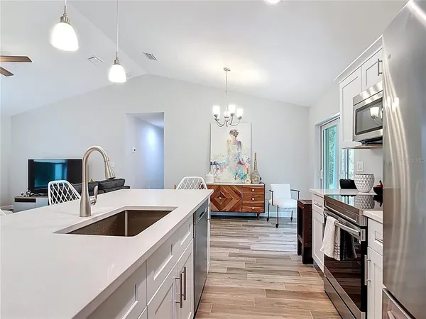a bathroom with a granite countertop sink a toilet and shower