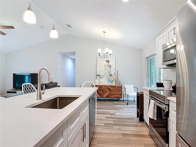 a bathroom with a granite countertop sink a toilet and shower